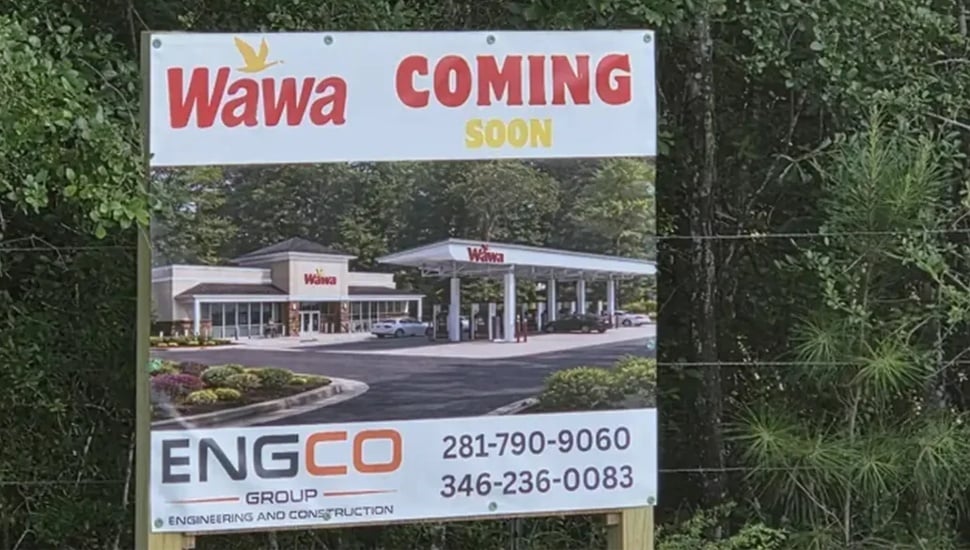 A "Wawa Coming Soon" sign bearing the branding of the convenience store chain.