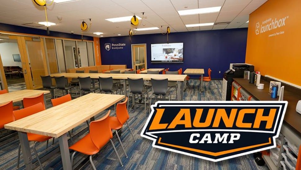 An empty classroom with a Launch Camp sign.